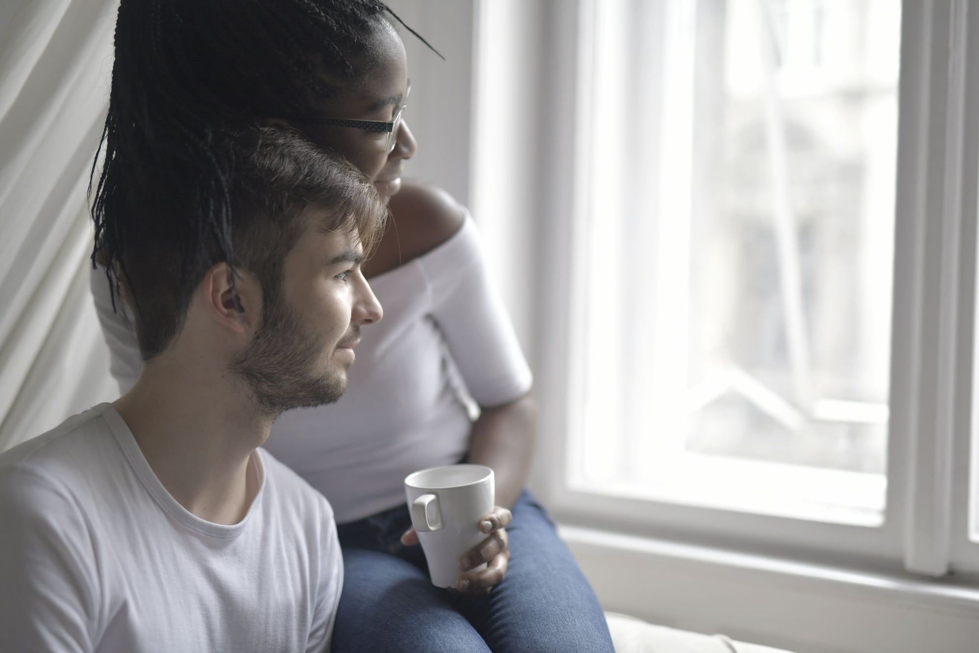 A couple sharing a quiet moment by a window